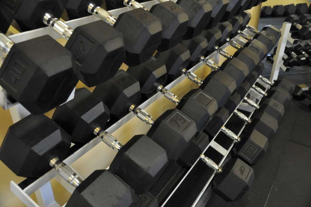 Rack of rubber-hex dumbbells in the Underground Fitness free-weight room