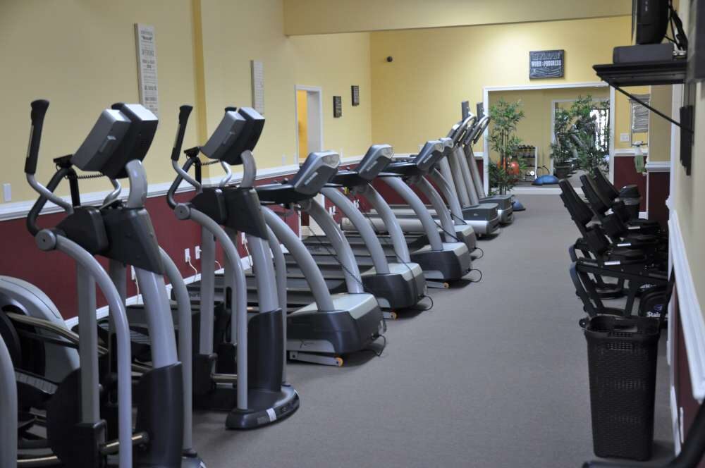 Row of treadmills and ellipticals in the Cardio Theatre