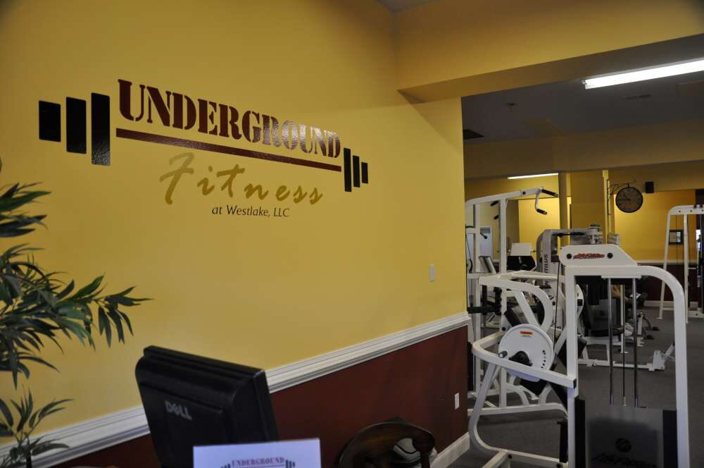 Underground Fitness logo on the wall above the strength-training floor