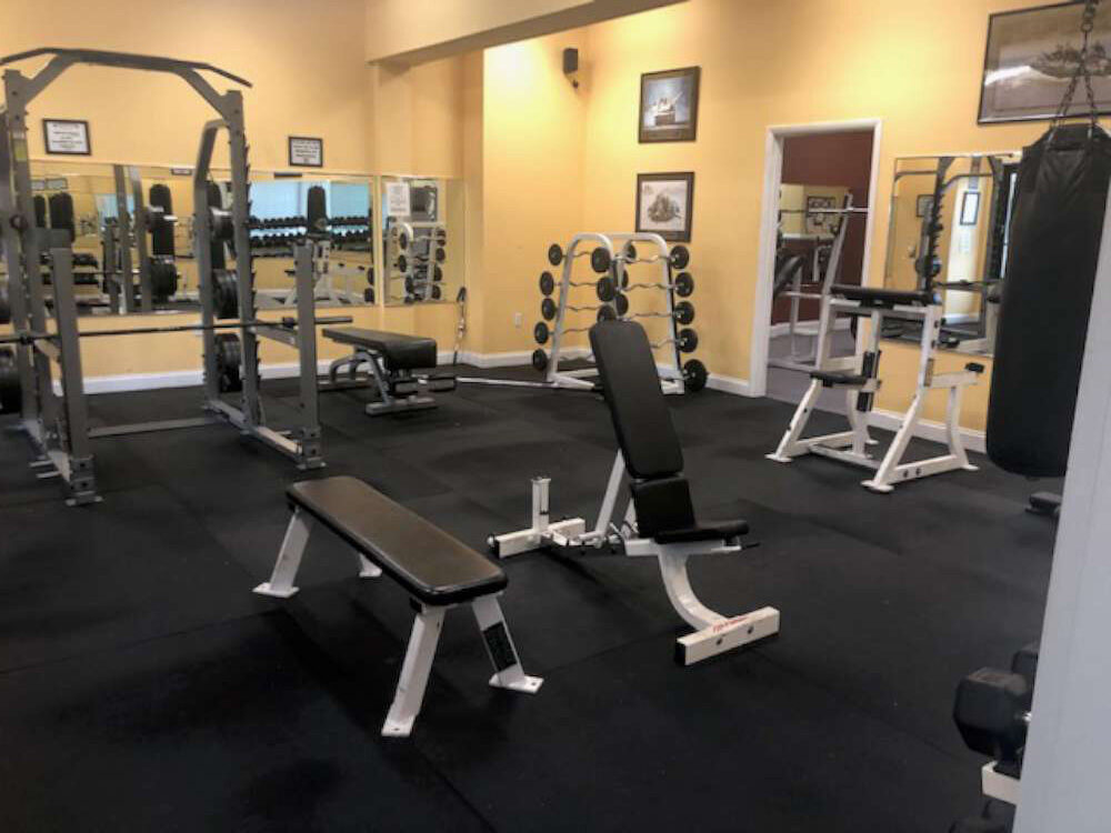 Adjustable benches and strength racks on the training floor